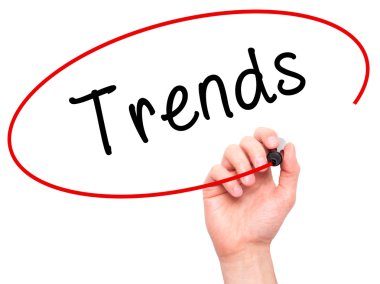 Man Hand writing Trends with marker on transparent wipe board