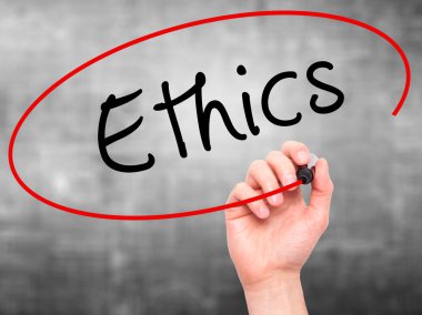 Man hand writing Ethics on visual screen