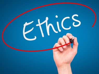Man hand writing Ethics on visual screen