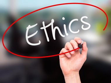 Man hand writing Ethics on visual screen