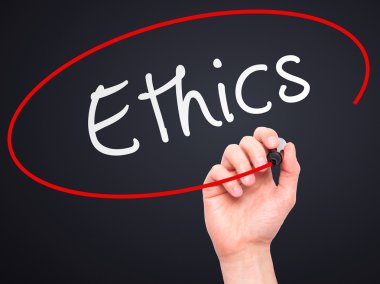 Man hand writing Ethics on visual screen