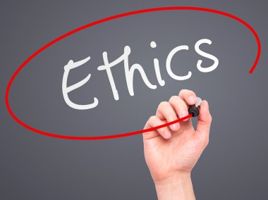 Man hand writing Ethics on visual screen