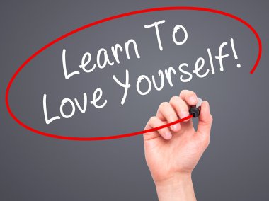 Man Hand writing Learn To Love Yourself with marker on transpare