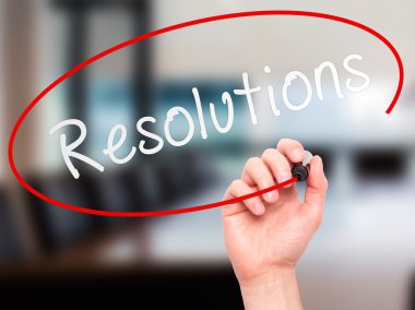 Man hand writing Resolutions on visual screen