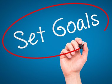 Man hand writing Set Goals on visual screen