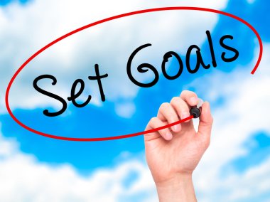 Man hand writing Set Goals on visual screen