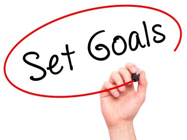 Man hand writing Set Goals on visual screen