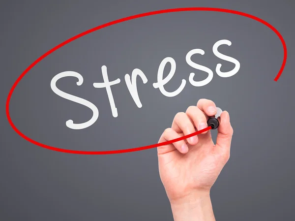 Man Hand writing Stress with marker on transparent wipe board — Stockfoto