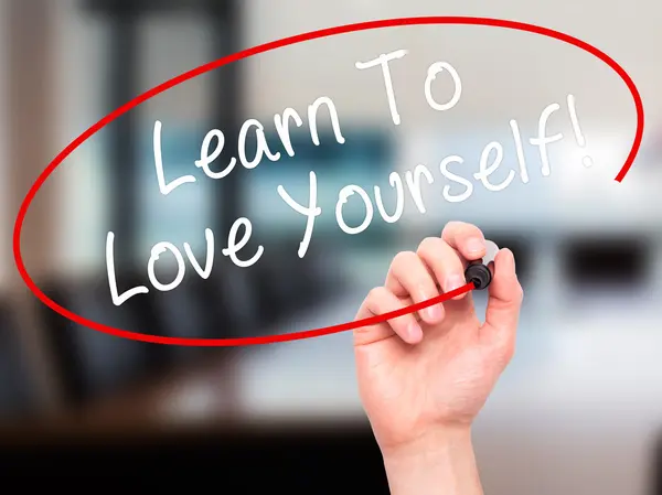 Man Hand writing Learn To Love Yourself with marker on transpare — Stock fotografie