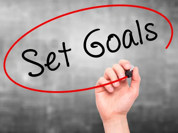 Man hand writing Set Goals on visual screen — Stockfoto