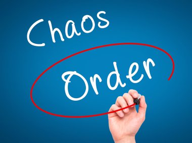 Man Hand writing and Choosing Order instead of Chaos with black 