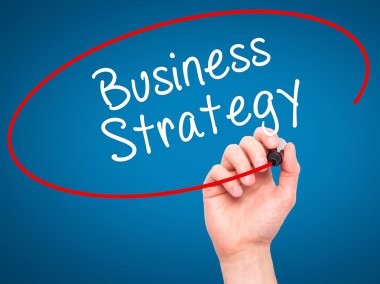 Man Hand writing Business Strategy with black marker on visual s