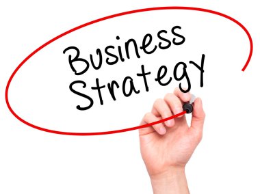 Man Hand writing Business Strategy with black marker on visual s