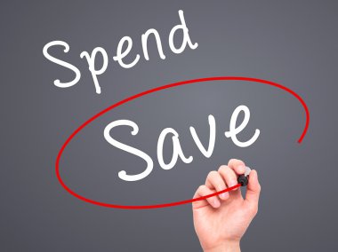Man Hand writing and choosing Save instead of Spend with black m
