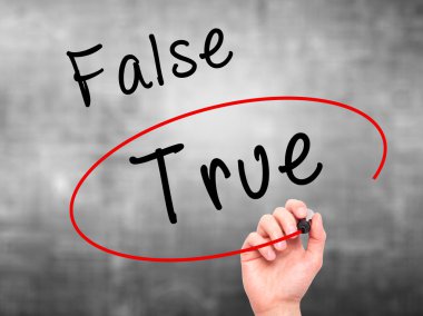 Man Hand writing an choosing True instead of False with black ma