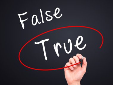 Man Hand writing an choosing True instead of False with black ma