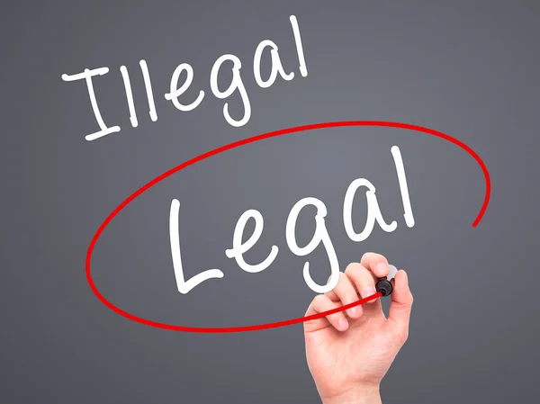 Man Hand writing and Choosing Legal instead of Illegal with blac — Stockfoto