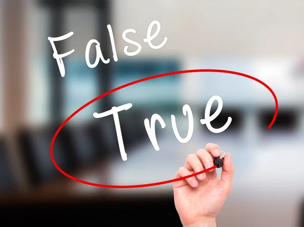 Man Hand writing an choosing True instead of False with black ma — Stockfoto