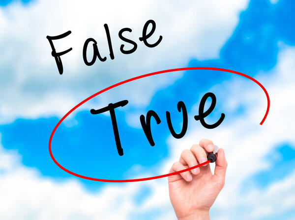 Man Hand writing an choosing True instead of False with black ma