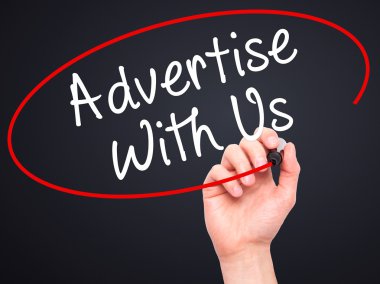 Man Hand writing Advertise With Us  with black marker on visual 