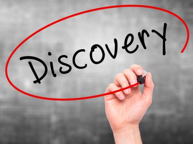 Man Hand writing Discovery with marker on transparent wipe board