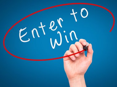 Man Hand writing Enter to Win with marker on transparent wipe bo