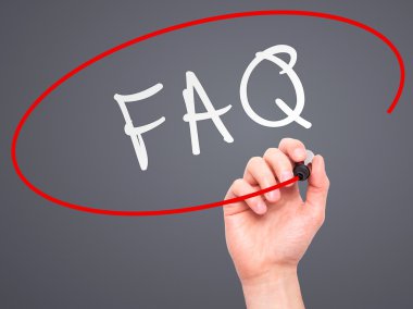 Man Hand writing FAQ - Frequently Asked Questions with marker on