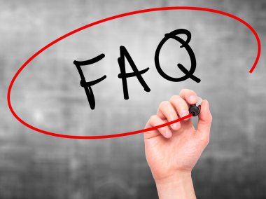 Man Hand writing FAQ - Frequently Asked Questions with marker on