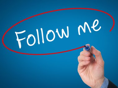 Man Hand writing Follow Me with marker on visual screen