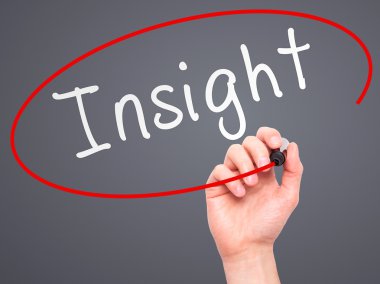 Man Hand writing Insight with marker on transparent wipe board