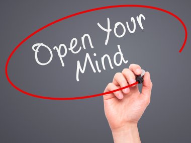 Man hand writing Open Your Mind with marker on transparent scree