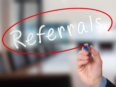 Man Hand writing Referrals with marker on virtual screen