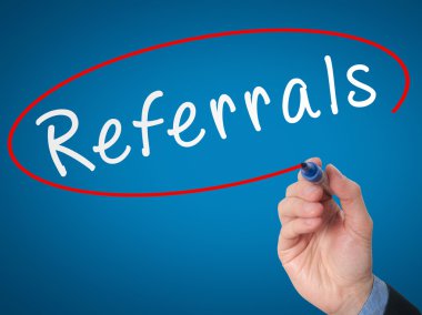 Man Hand writing Referrals with marker on virtual screen