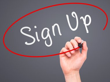 Man Hand writing Sign Up with marker on transparent wipe board