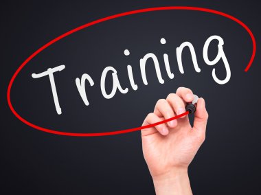 Man Hand writing Training with marker on transparent wipe board