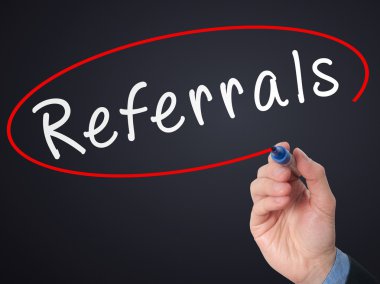 Man Hand writing Referrals with marker on virtual screen