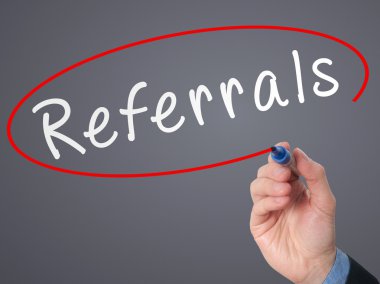 Man Hand writing Referrals with marker on virtual screen