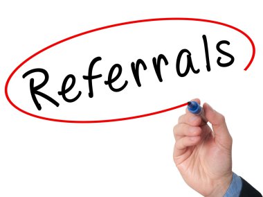 Man Hand writing Referrals with marker on virtual screen