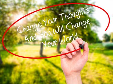Man Hand writing Change Your Thoughts And You Will Change Your W