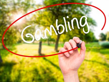 Man Hand writing Gambling  with black marker on visual screen