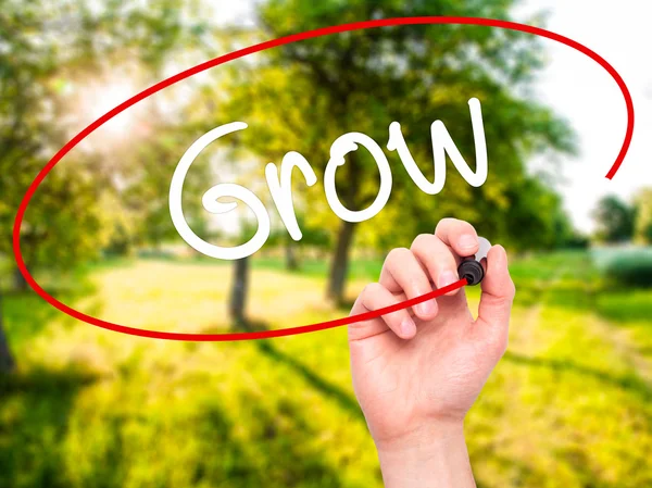 Man Hand writing  Grow with black marker on visual screen — Stock Photo, Image