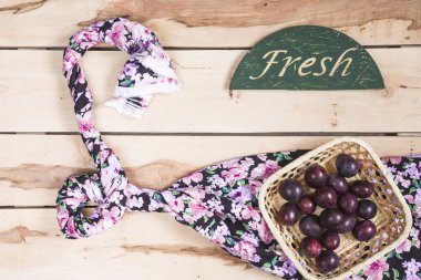 Ripe plums on the wooden background