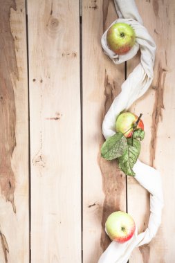 Ripe seasonal apples on the wooden backround