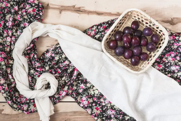 Ripe plums on the wooden background