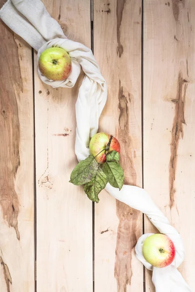 Ripe seasonal apples on the wooden backround
