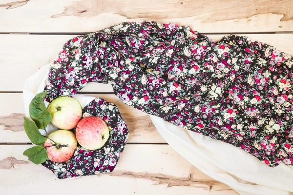 Ripe seasonal apples on the wooden backround