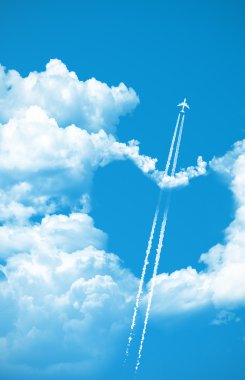 Airplane fly over a heart on the sky clipart
