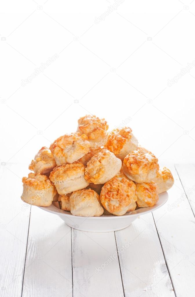 Home made cheese scones on white wood background