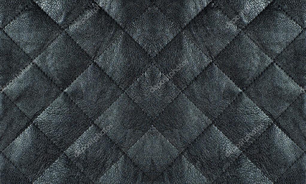 Black quilted leather fabric close up, abstract background — Stock