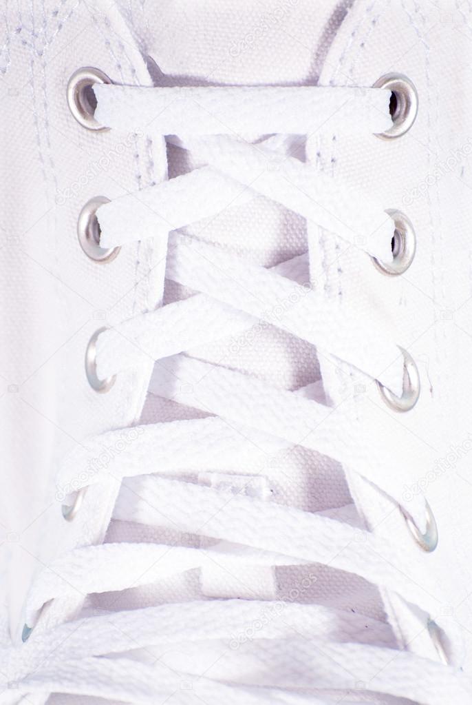 White lace on white sneakers close up